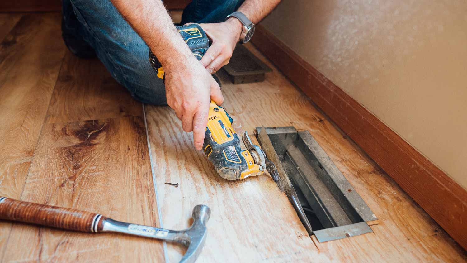 A person replacing ductwork