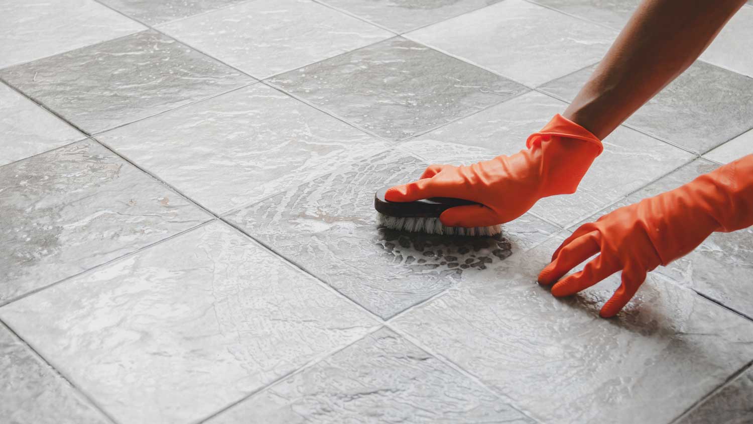 A person scrubbing the floor with a brush