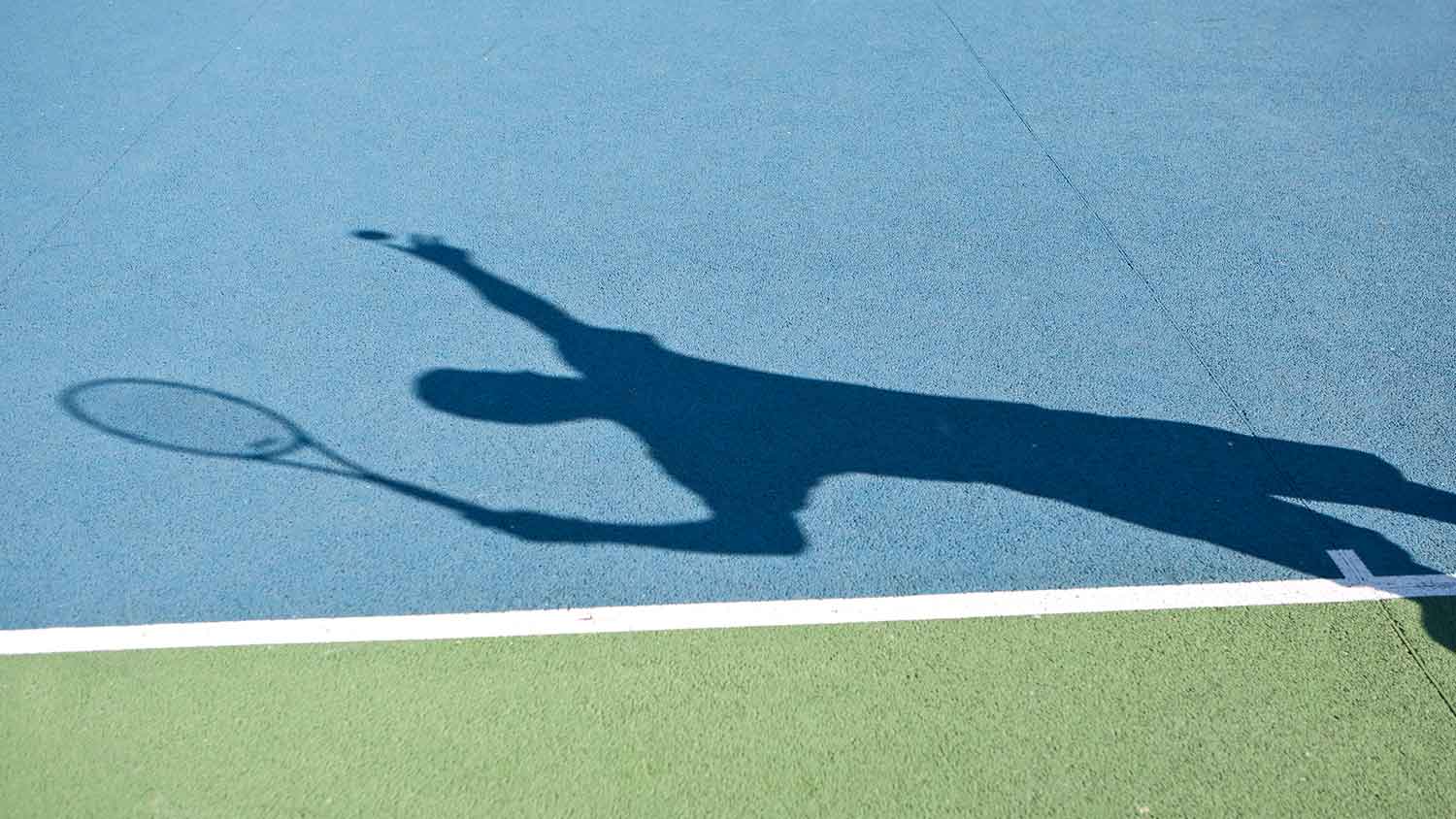 A person ready to serve a tennis ball