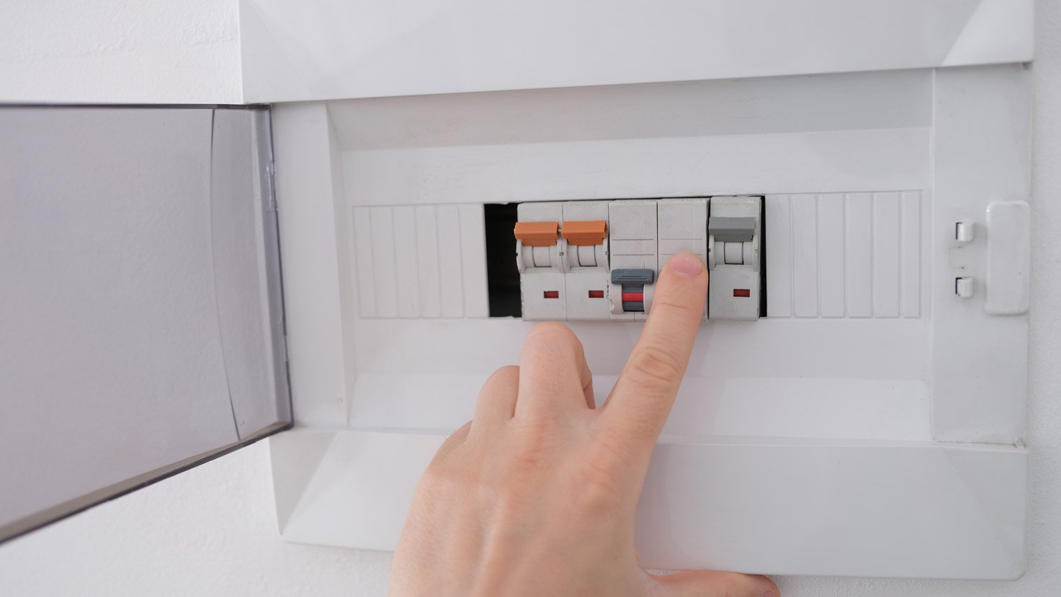 A person turning off the electricity
