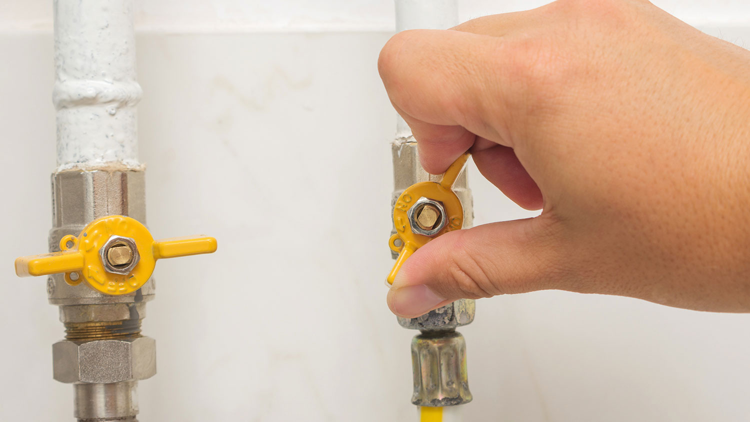 A person turning off the water