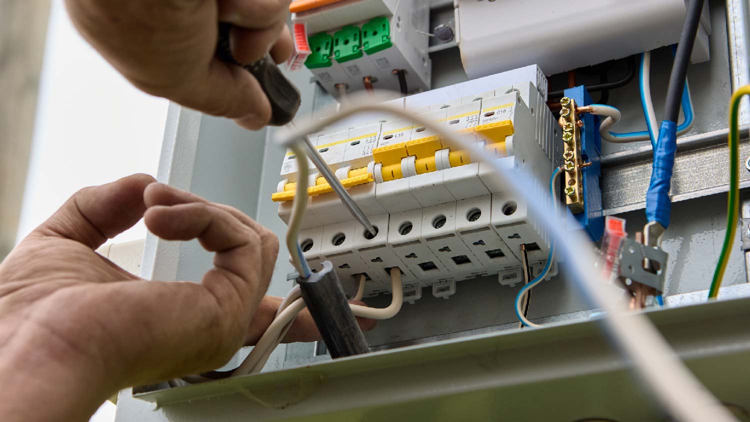 A person upgrading an electrical panel