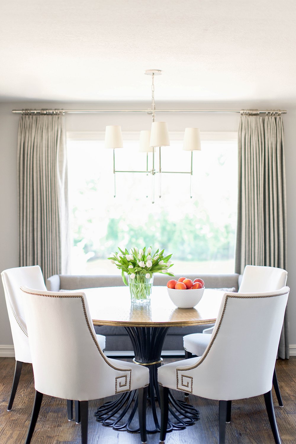 pewter dining room with dark floors 