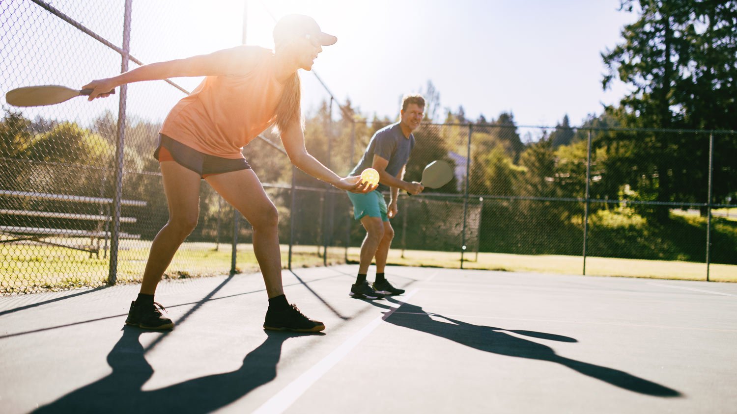 Couple Playing Pickleball Game On Summer Morning