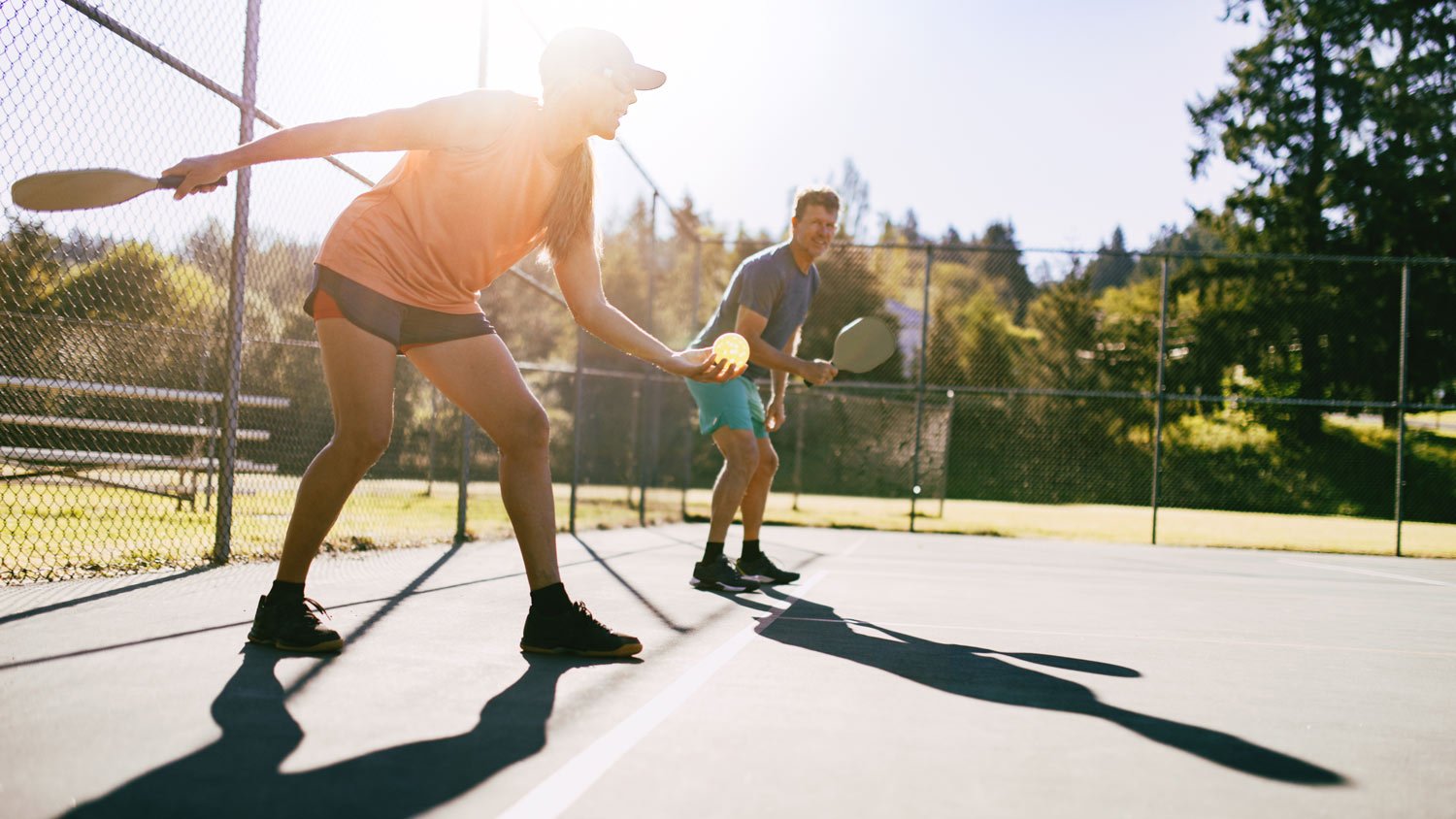 Couple Playing Pickleball Game On Summer Morning  