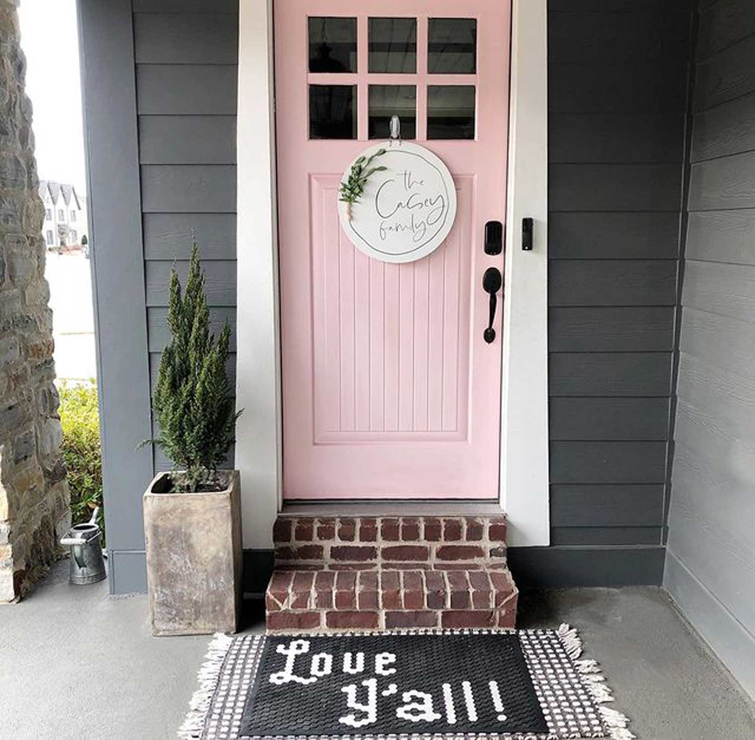 Light pink front door with white frame