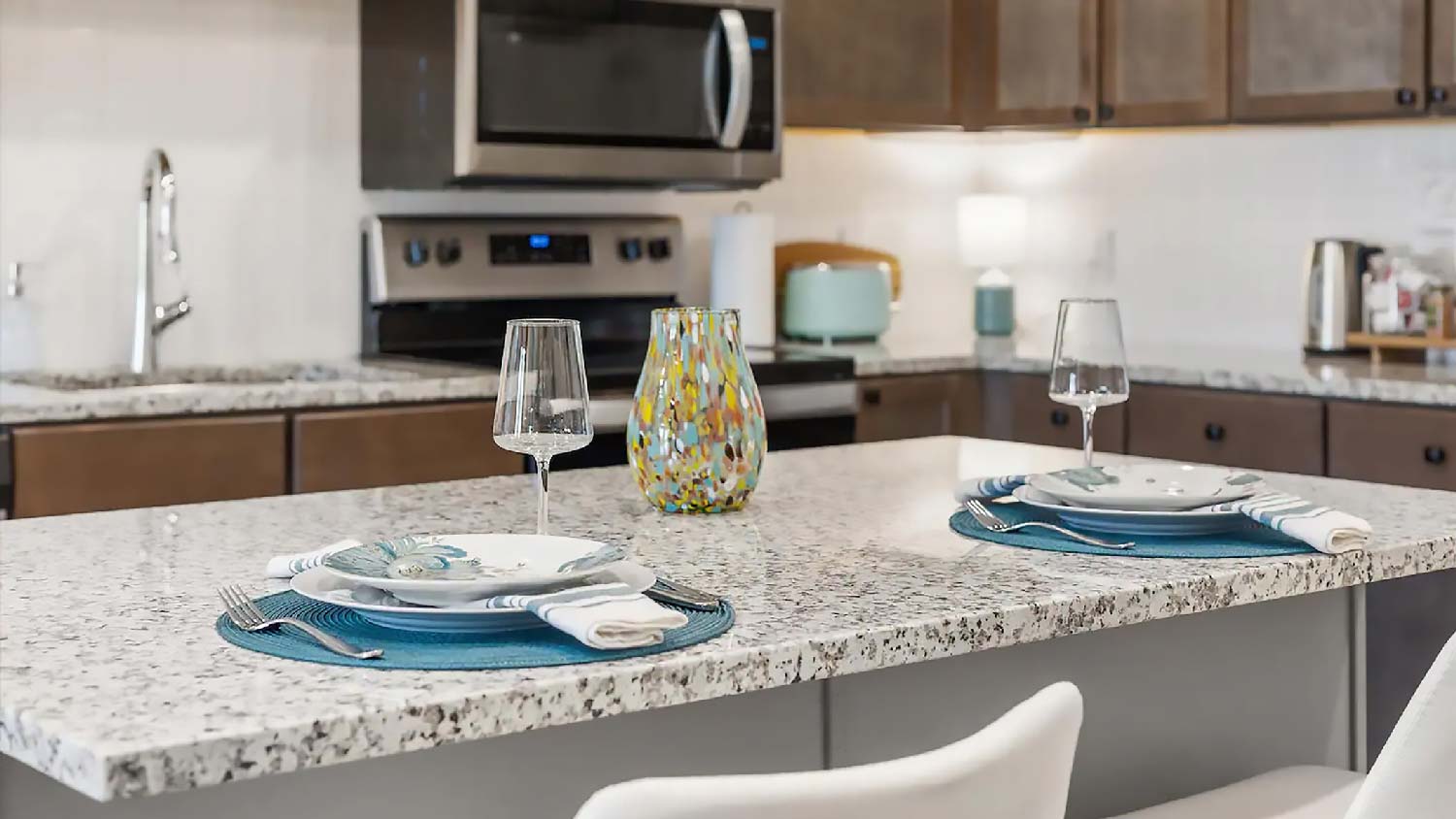 Placemats under dinner plates on a granite kitchen island 
