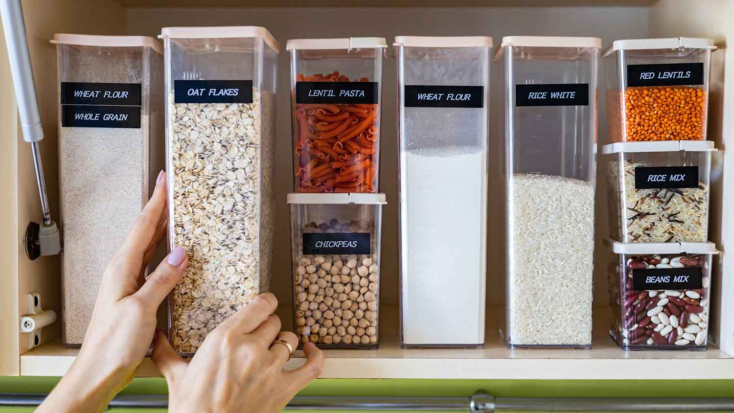 Woman placing container with food in the cabinet