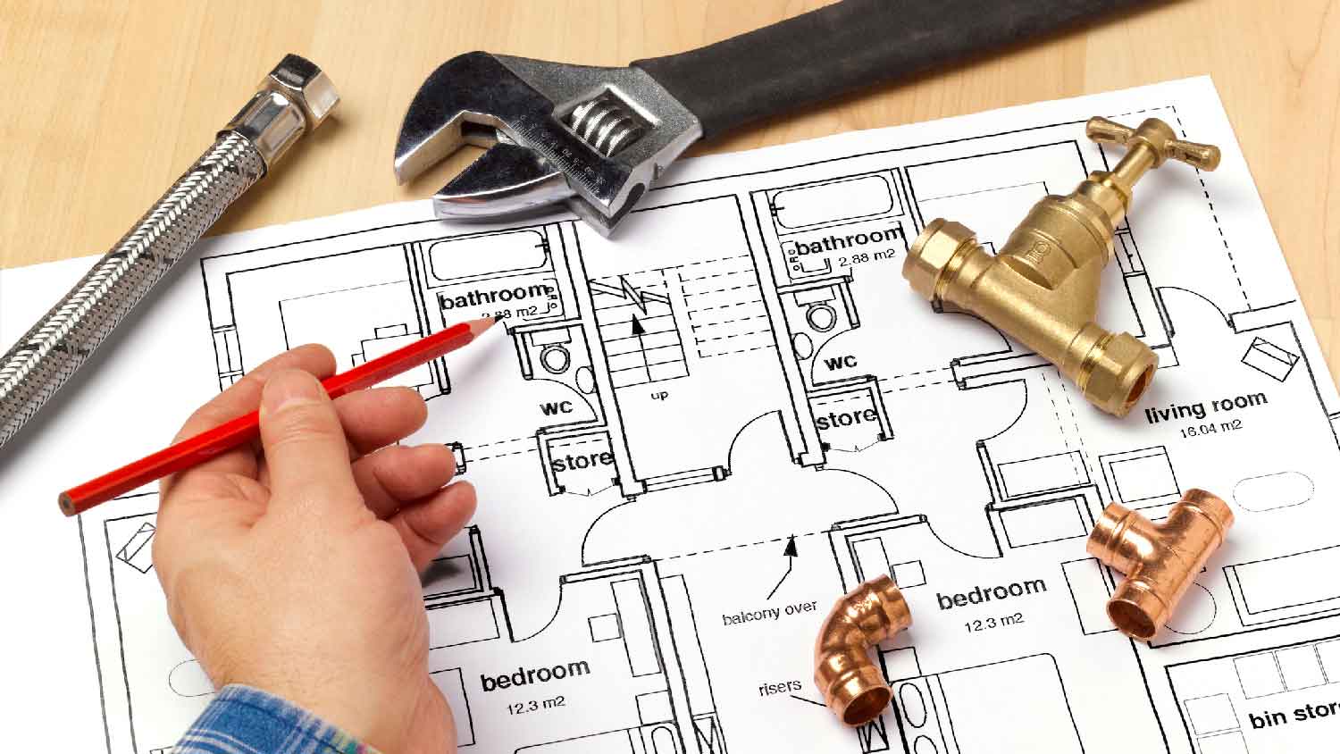 A plumber calculating square footage of house