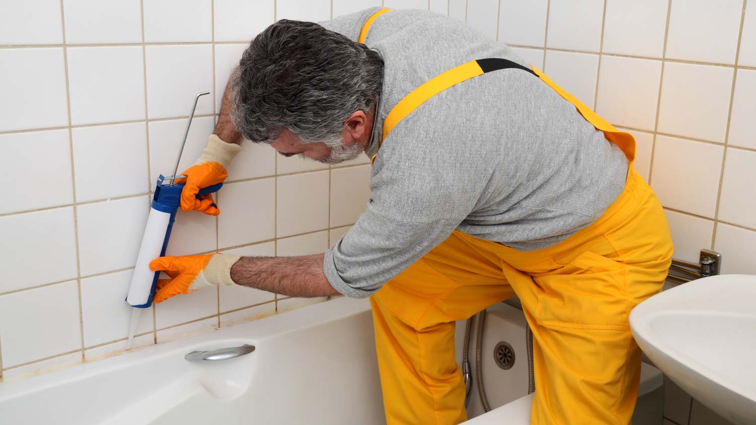 plumber caulking bathtub