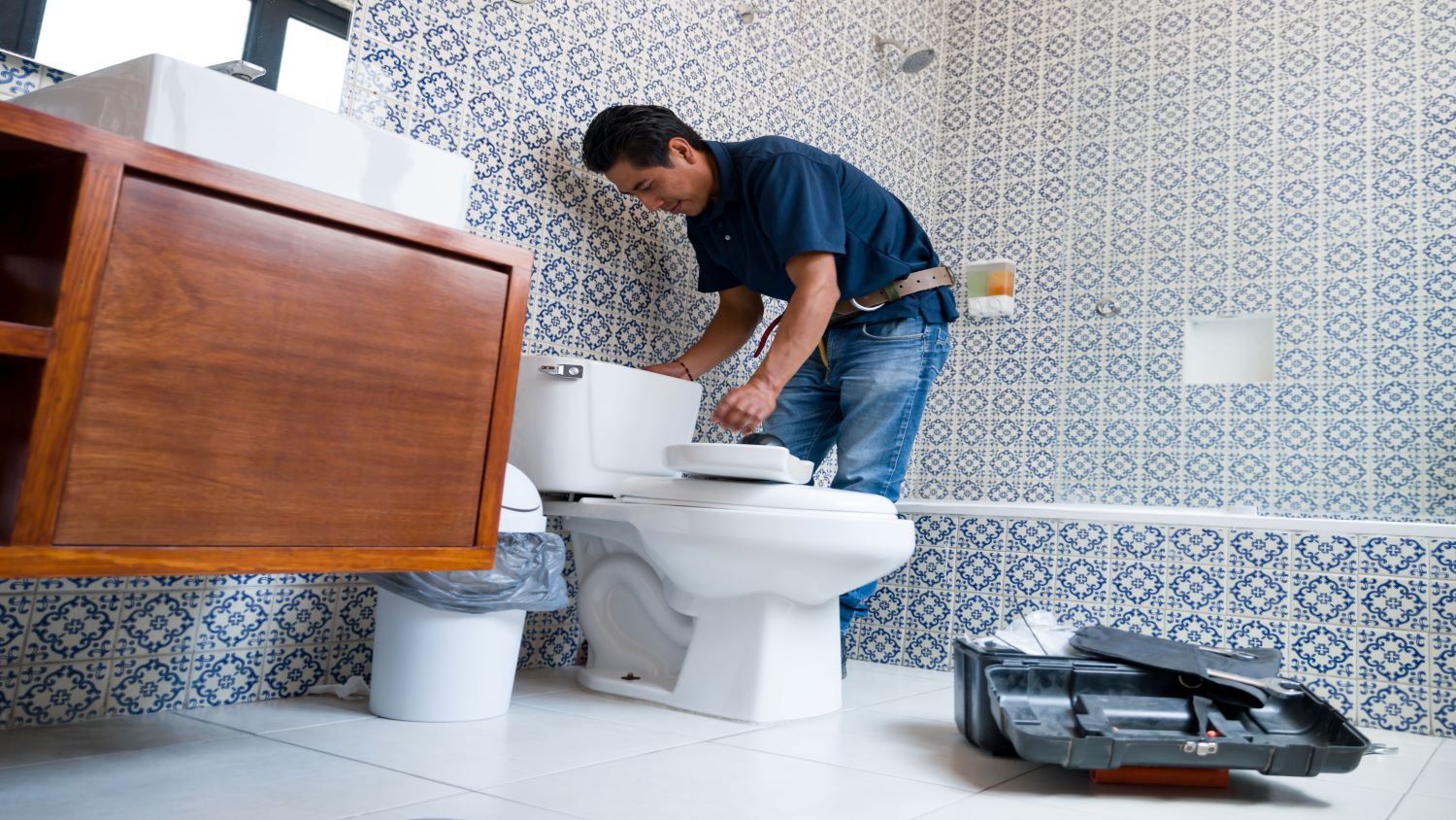 professional plumber fixing toilet