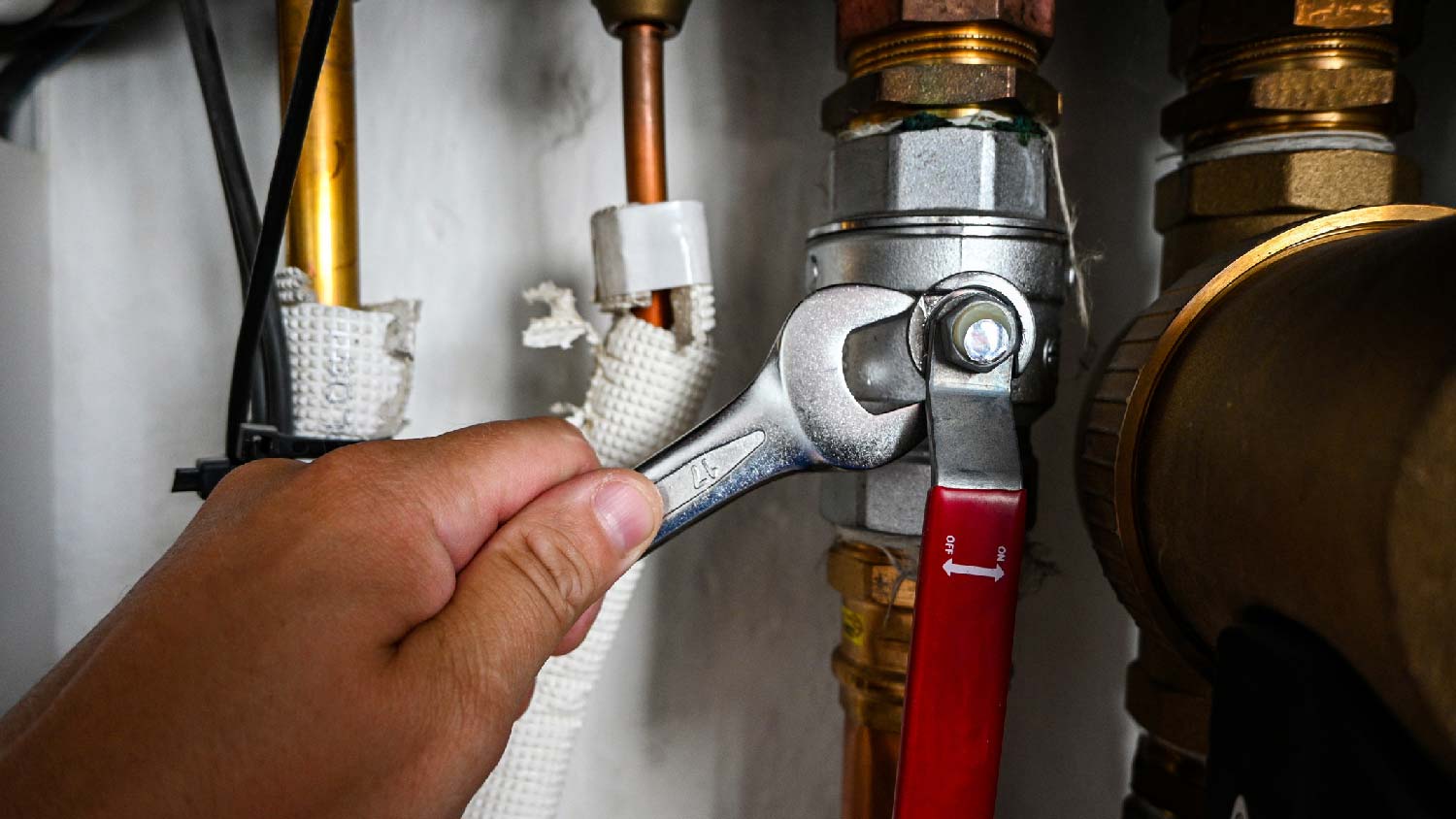 A plumber installing a diverter valve