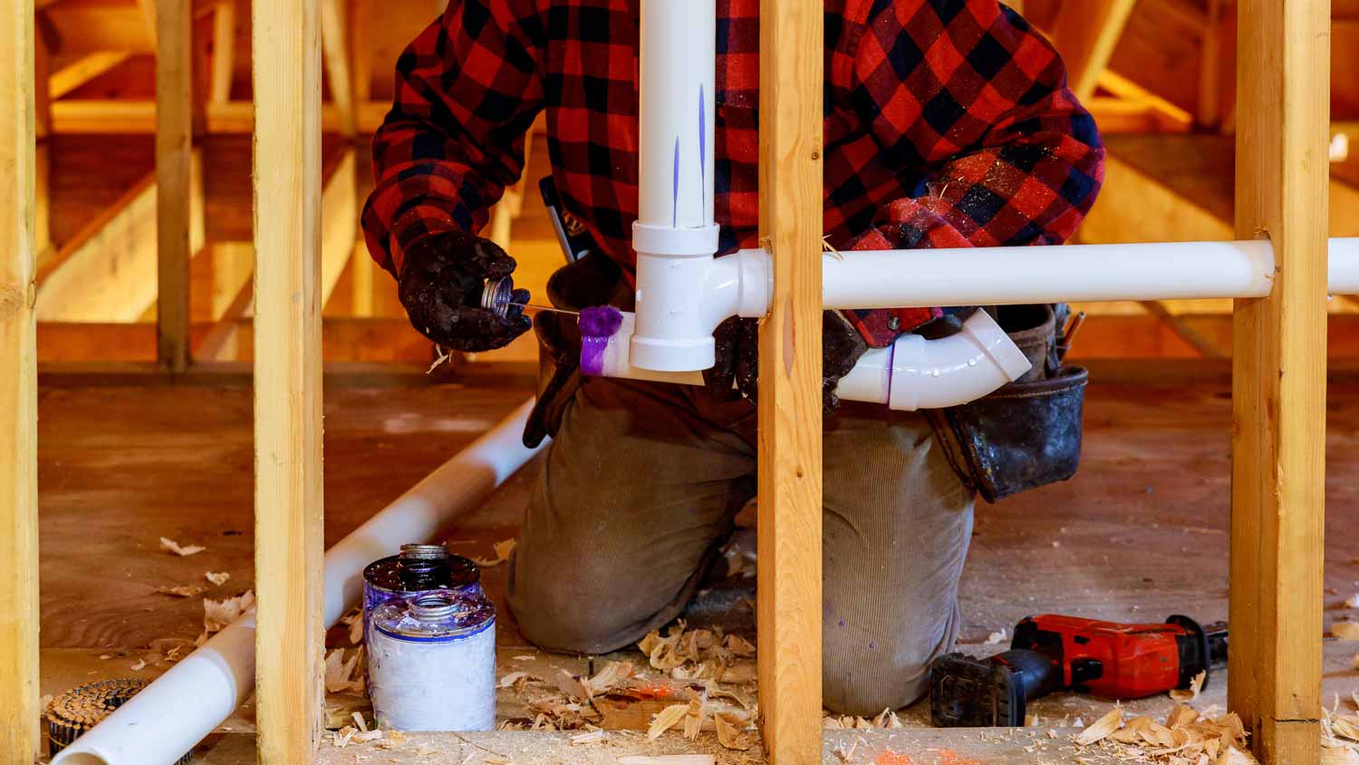 A plumber rerouting a plumbing vent