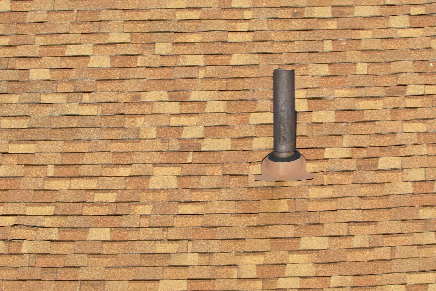 Vent stack for bathroom plumbing gasses and odors on a residential roof