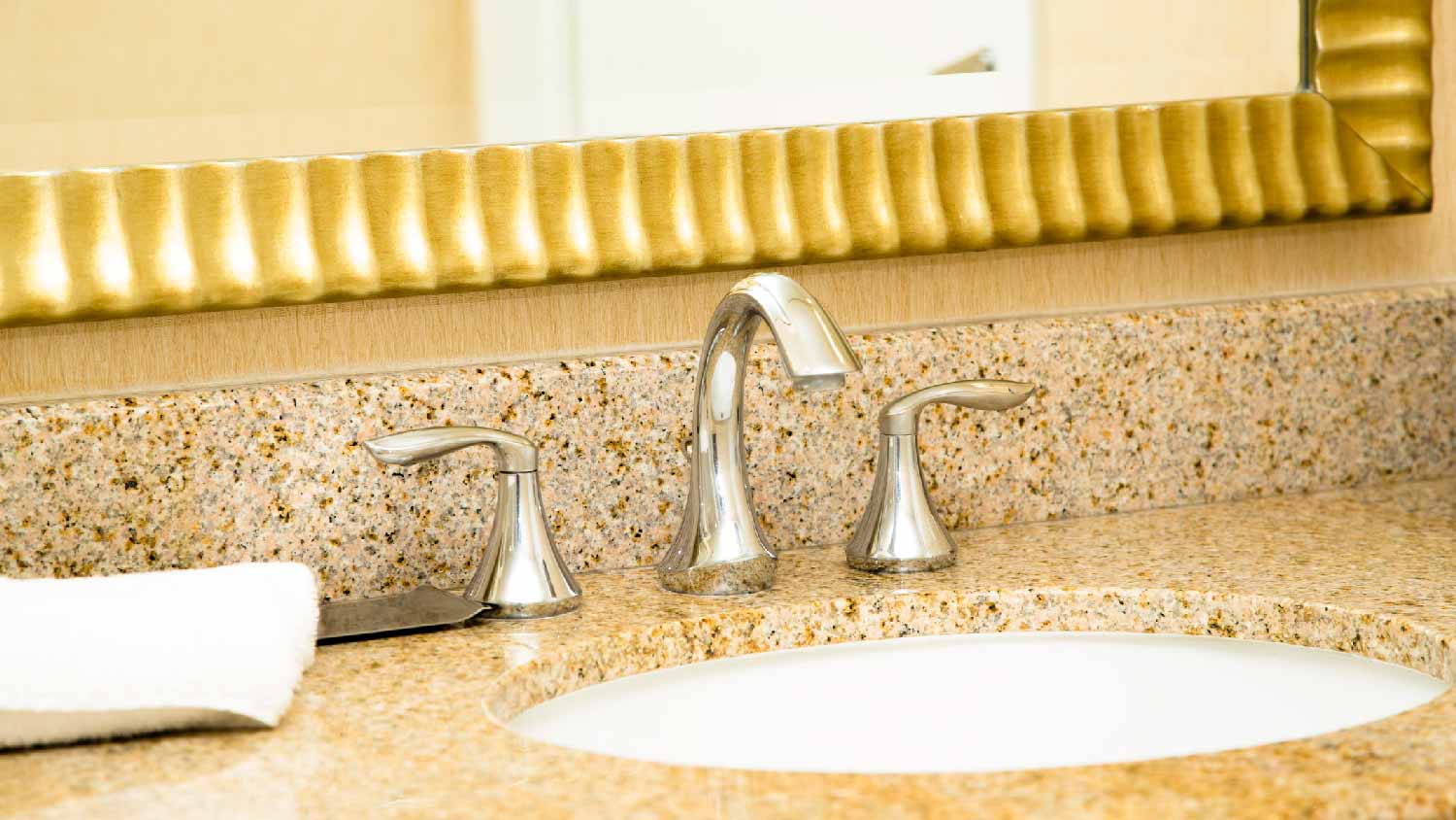 A polished nickel faucet in an upscale bathroom