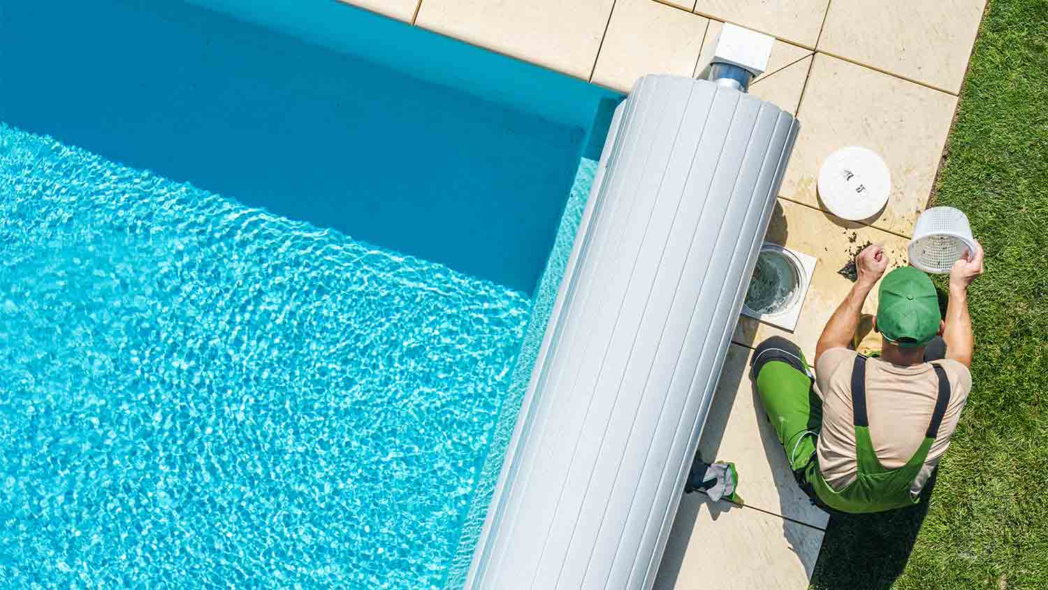 worker performing pool filter maintenance 