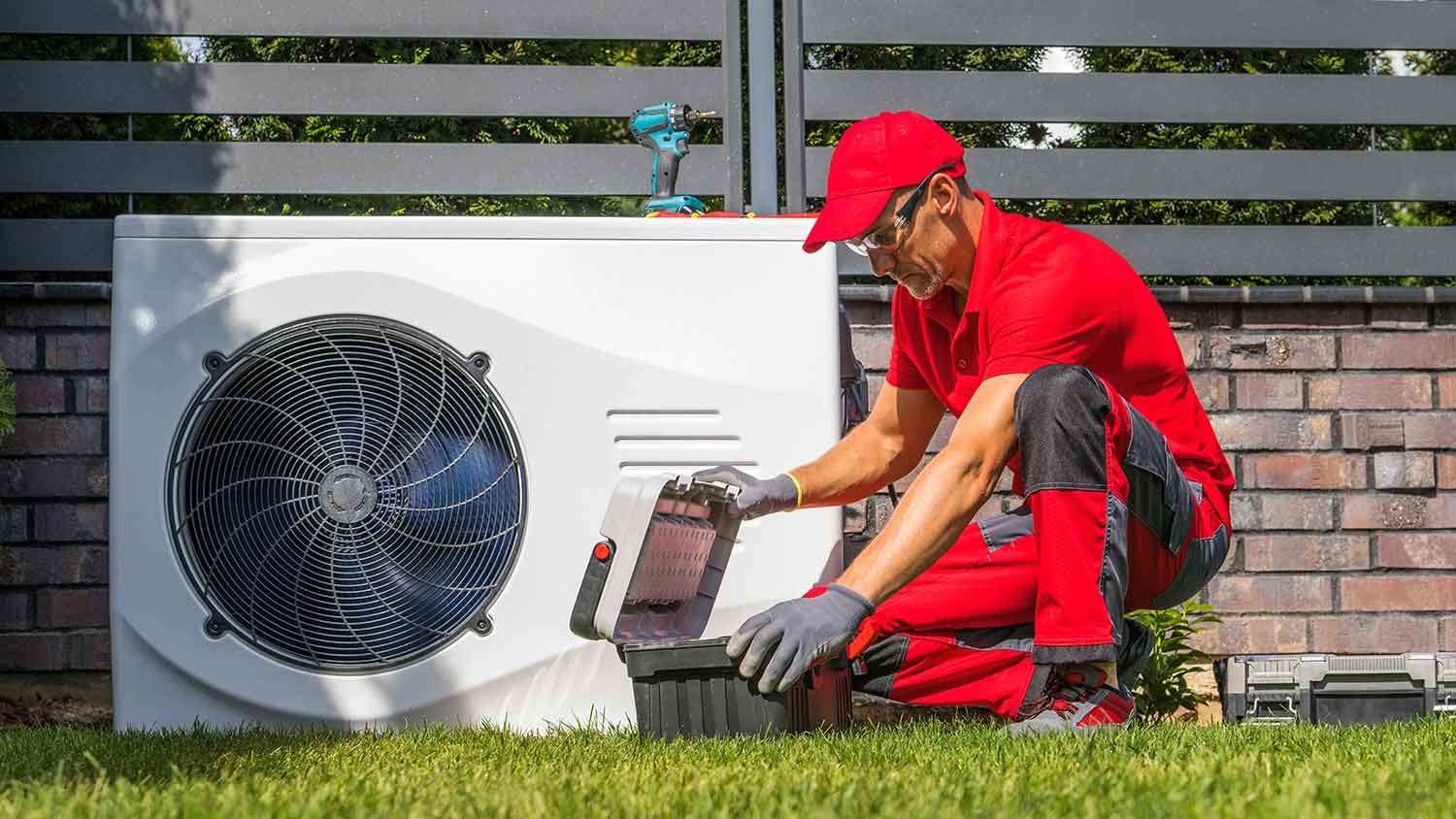 Technician installing swimming pool heat pump