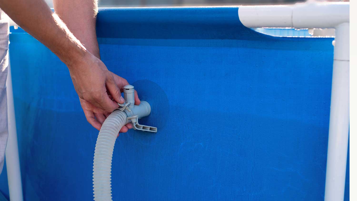 Man checking plumbing of a swimming pool