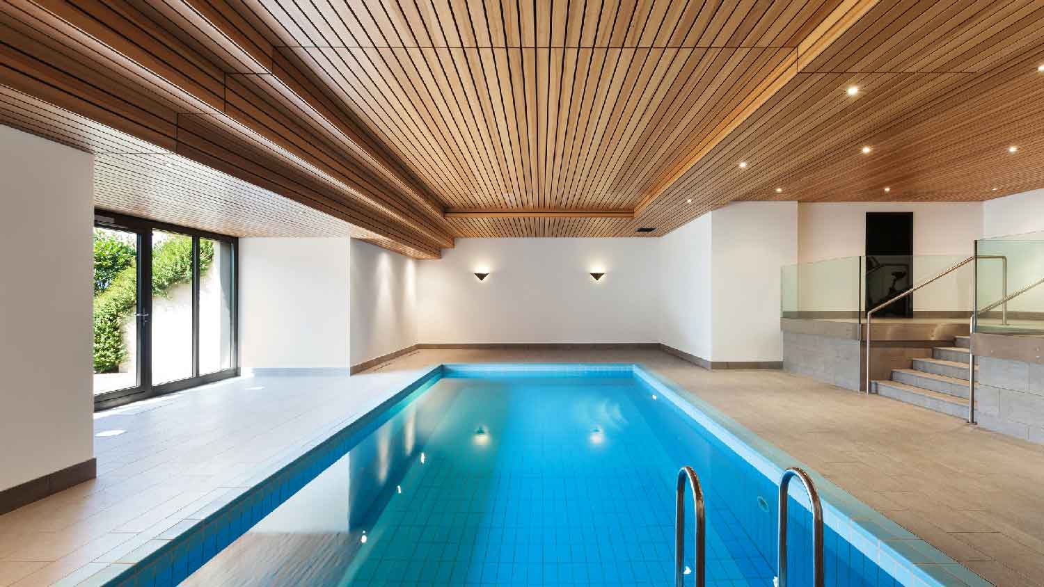 An indoor pool with recessed lights having shower trim to avoid moisture