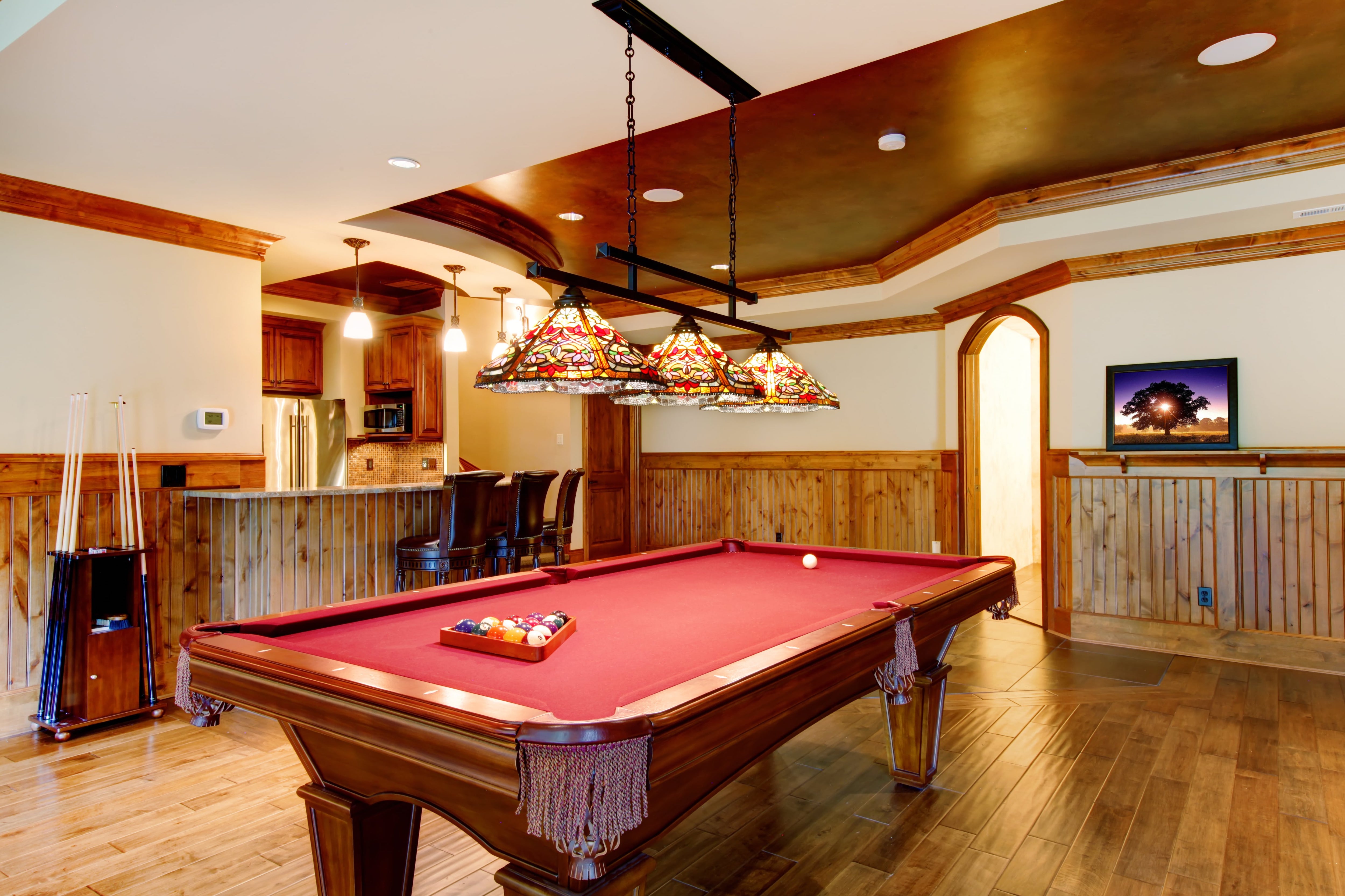 Pool table and bar in basement