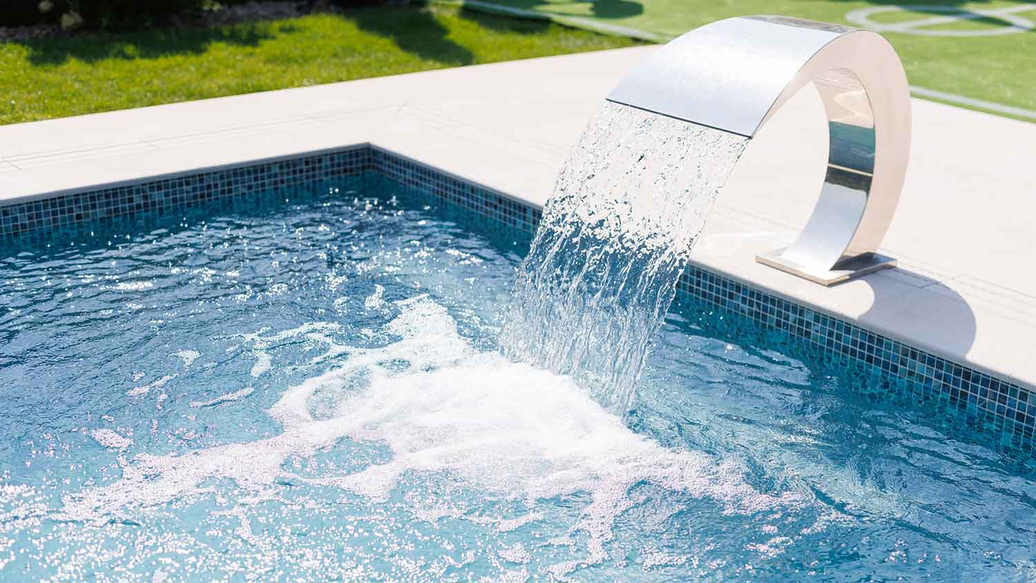 Pool waterfall pouring water into the pool