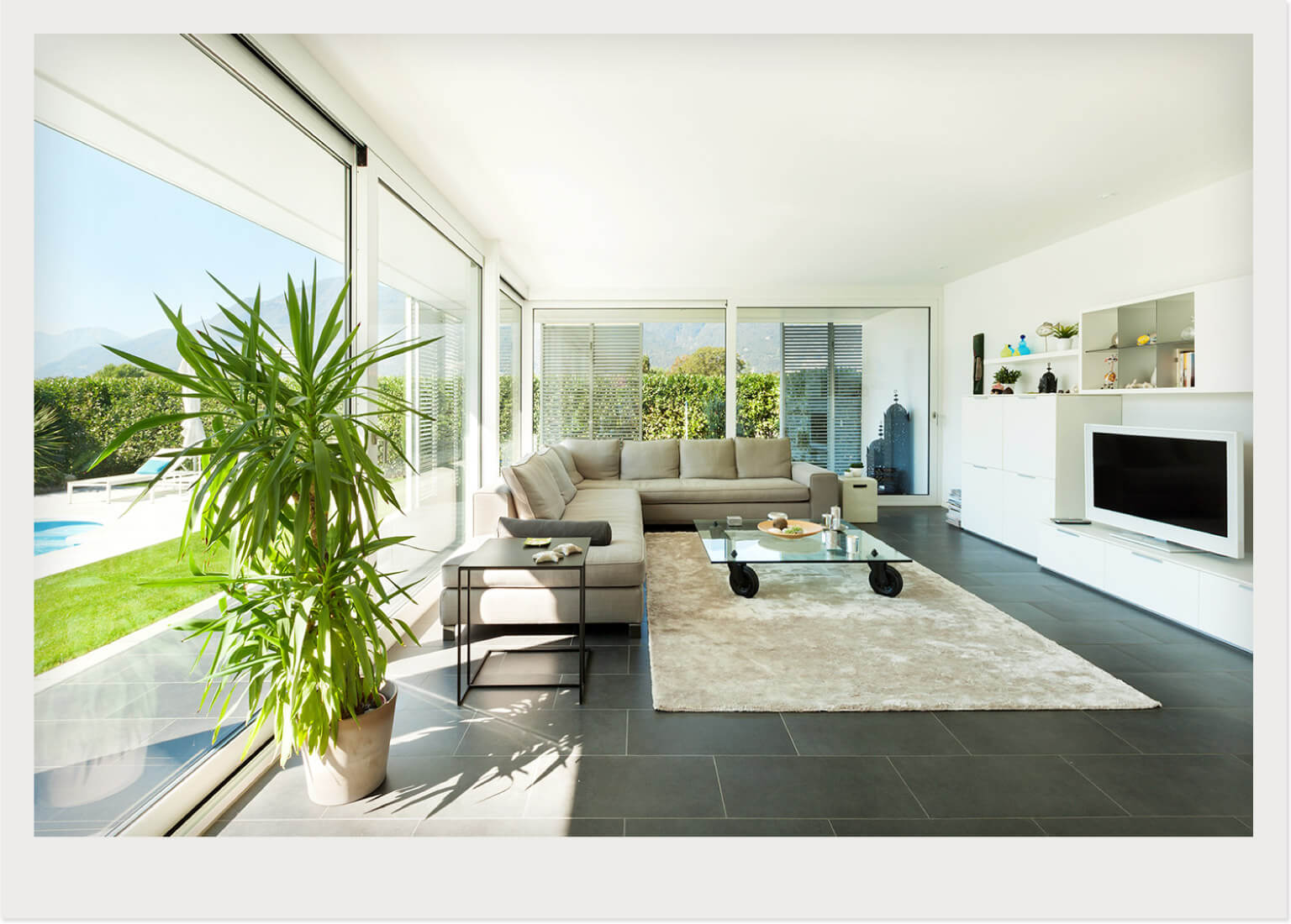 poolside sunroom with couch and TV