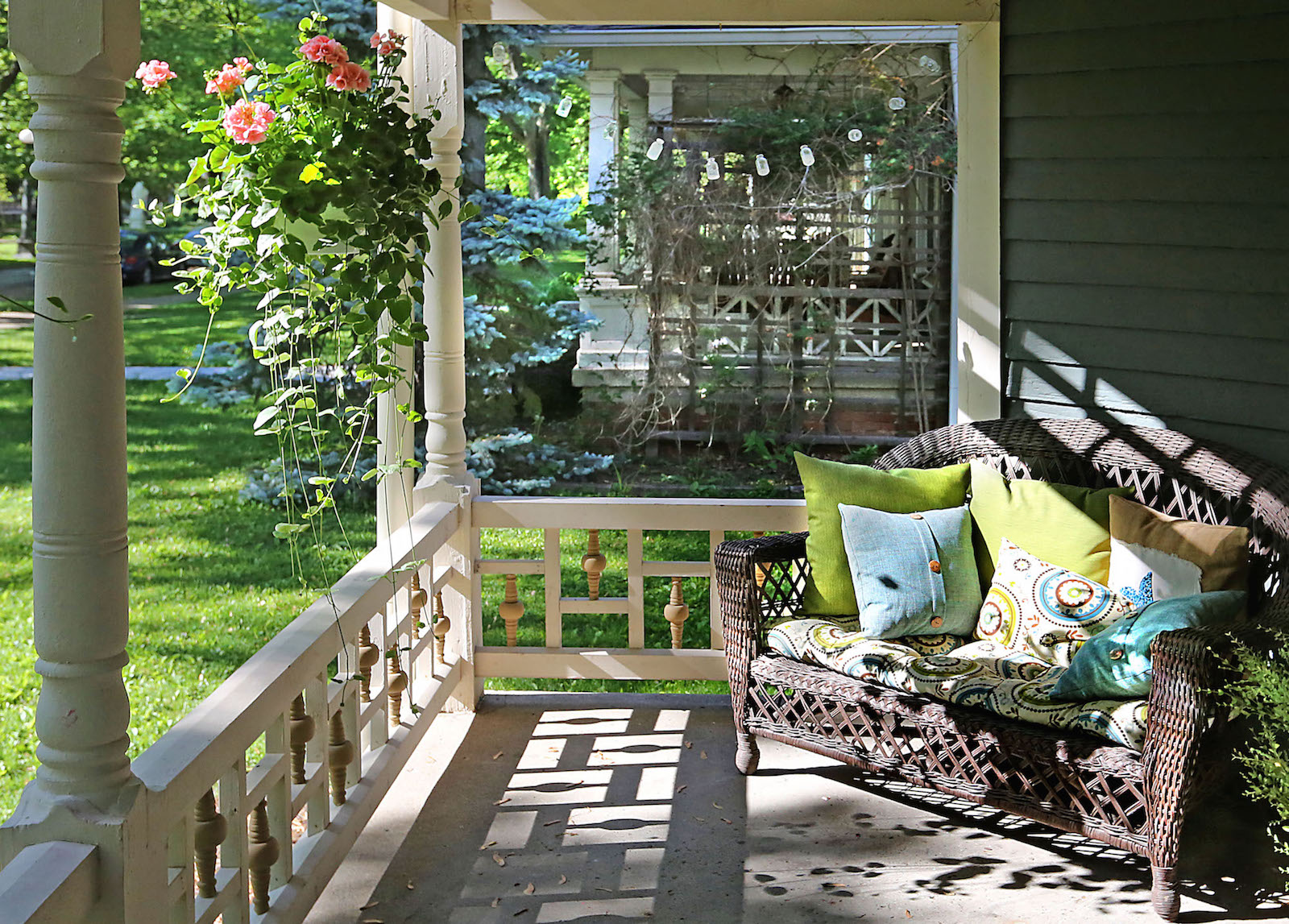 front porch with love seat and hanging flowers