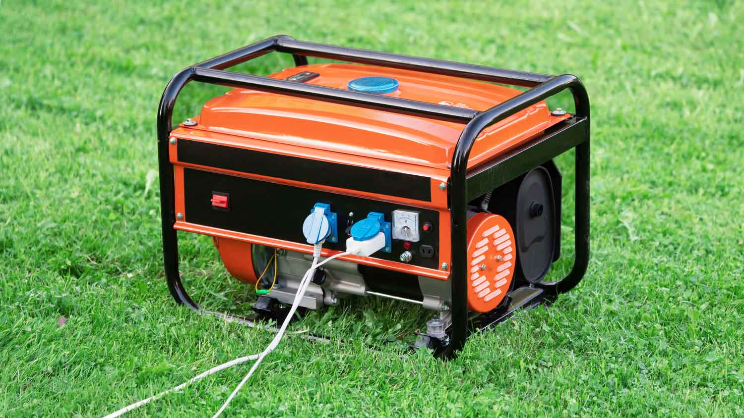 Portable electric generator on the grass