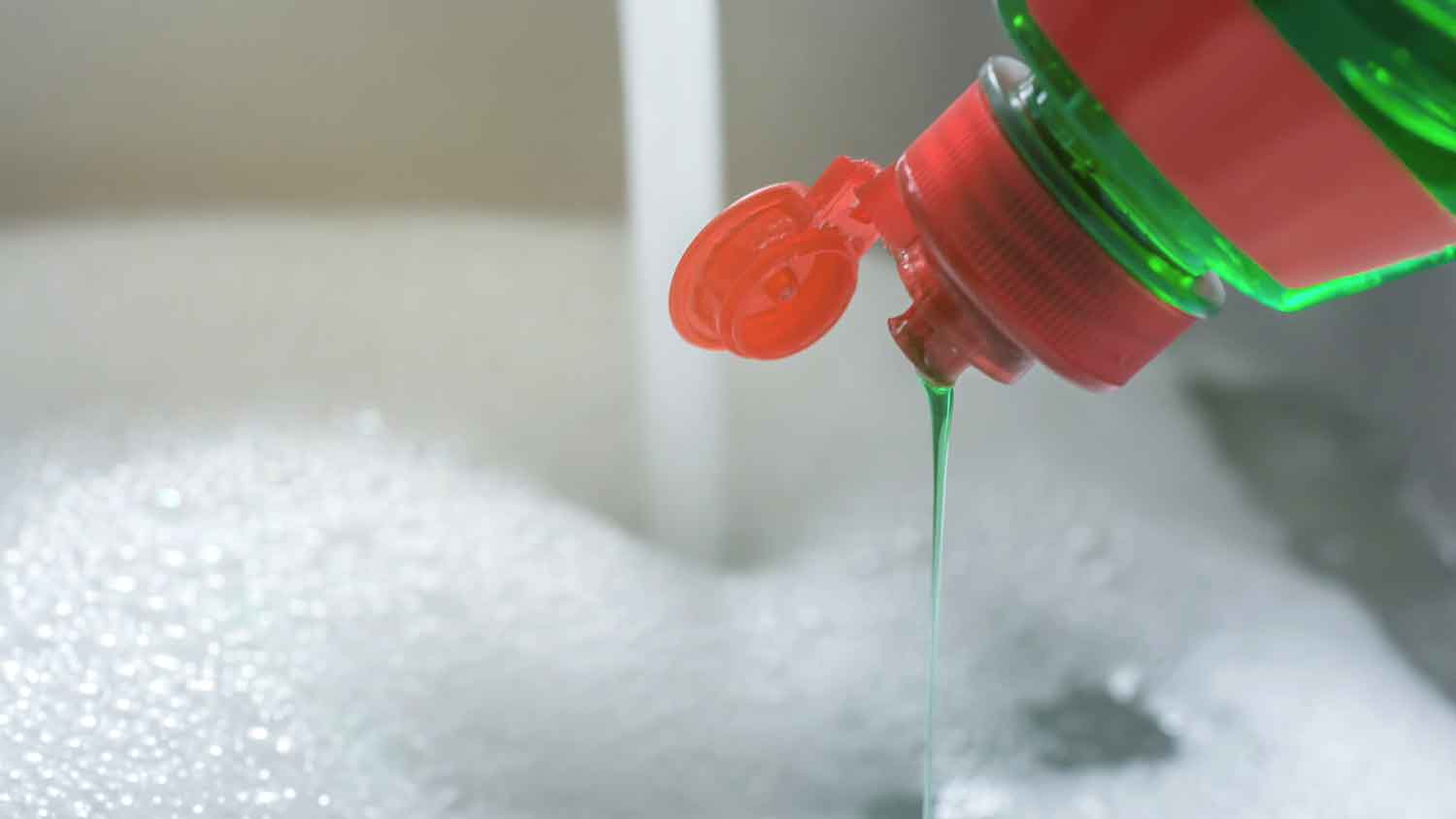 Pouring liquid dish soap in the sink