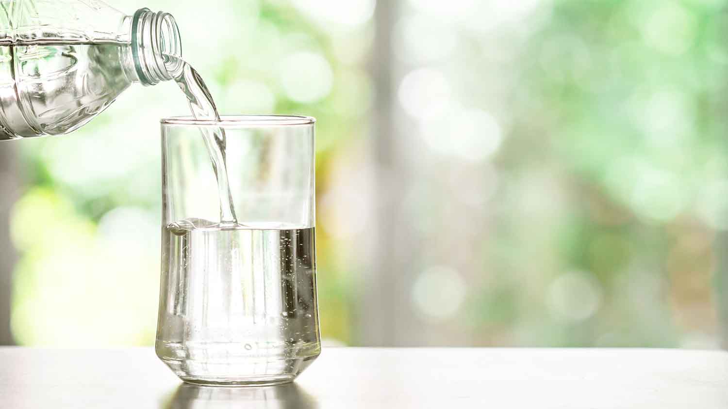 Pouring purified water in a glass 