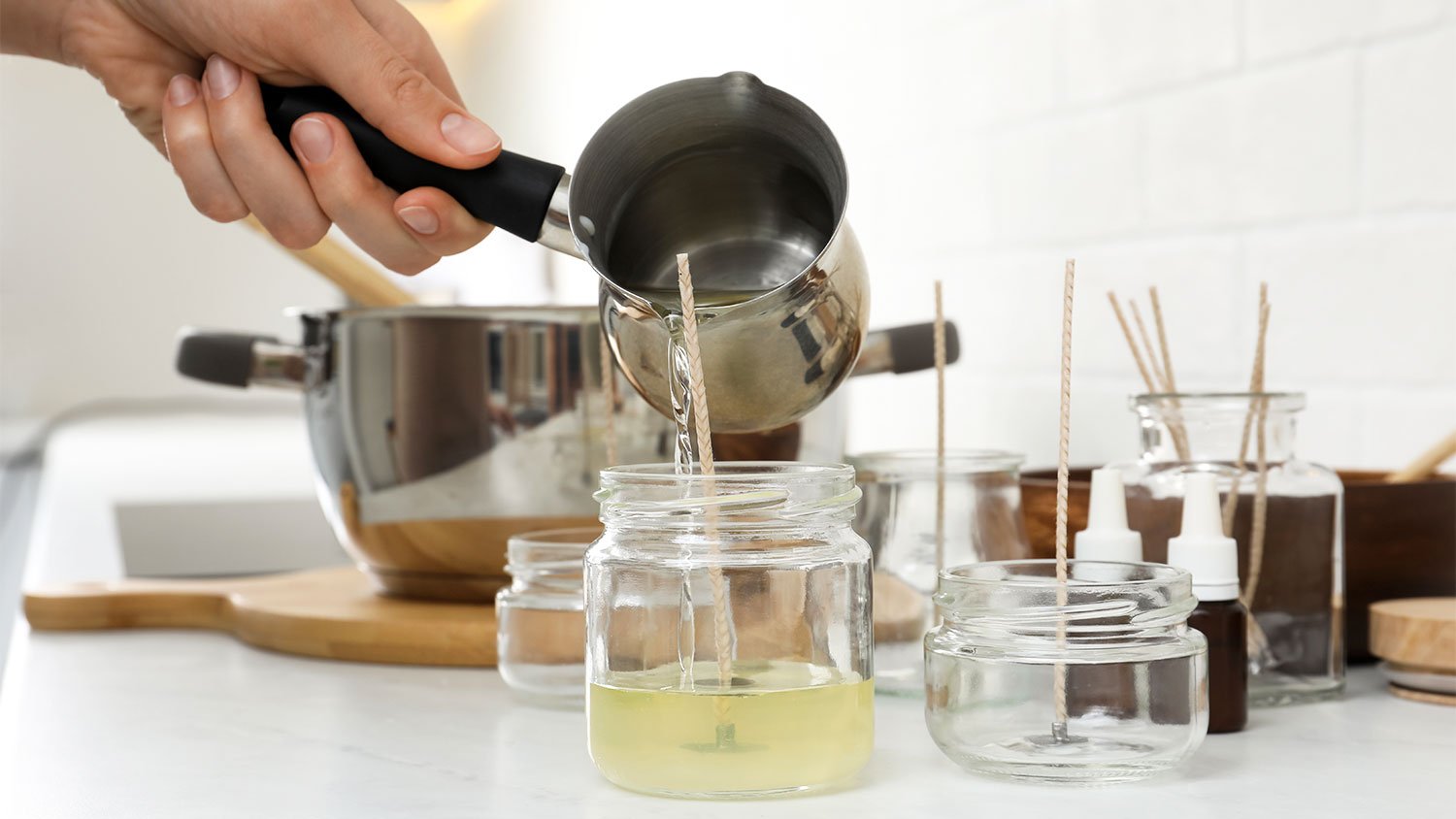 Pouring wax into candle containers