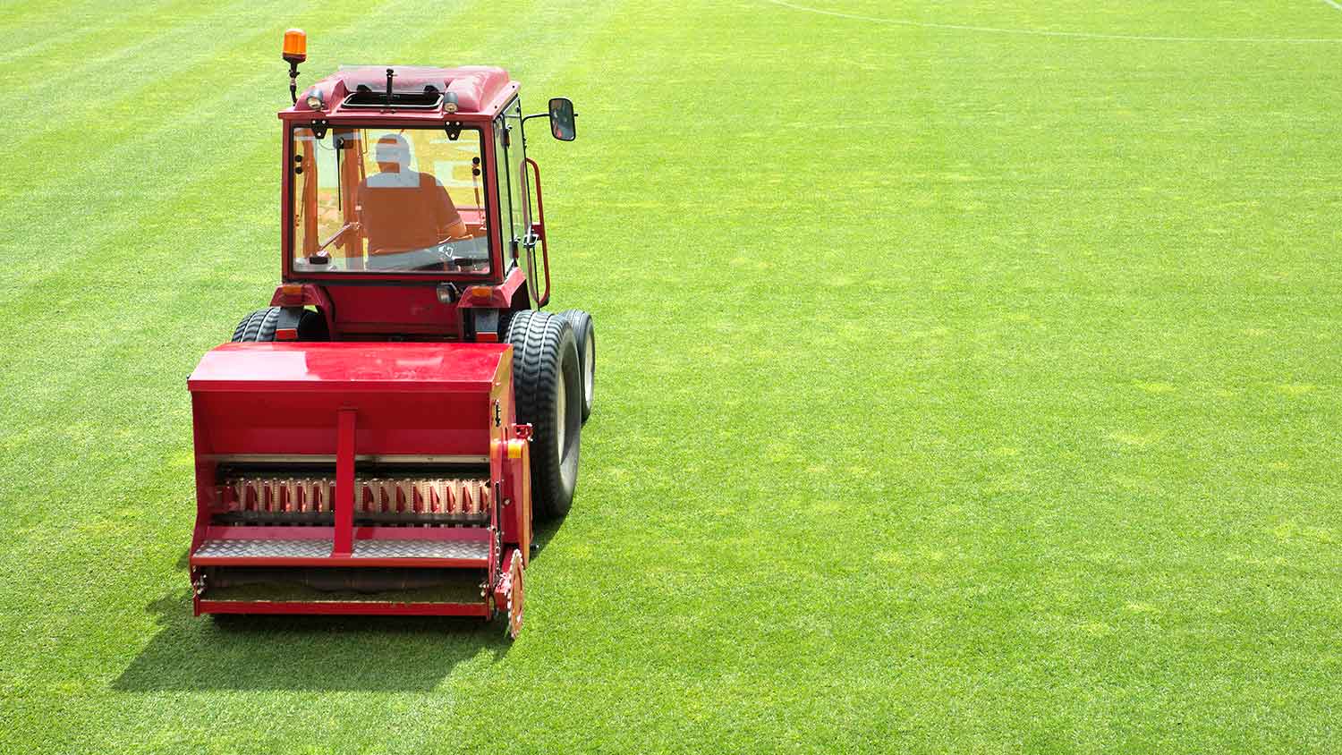 Adding grass into the lawn with power seeding machine