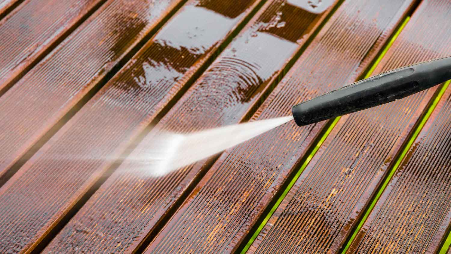 Power washing a wooden patio