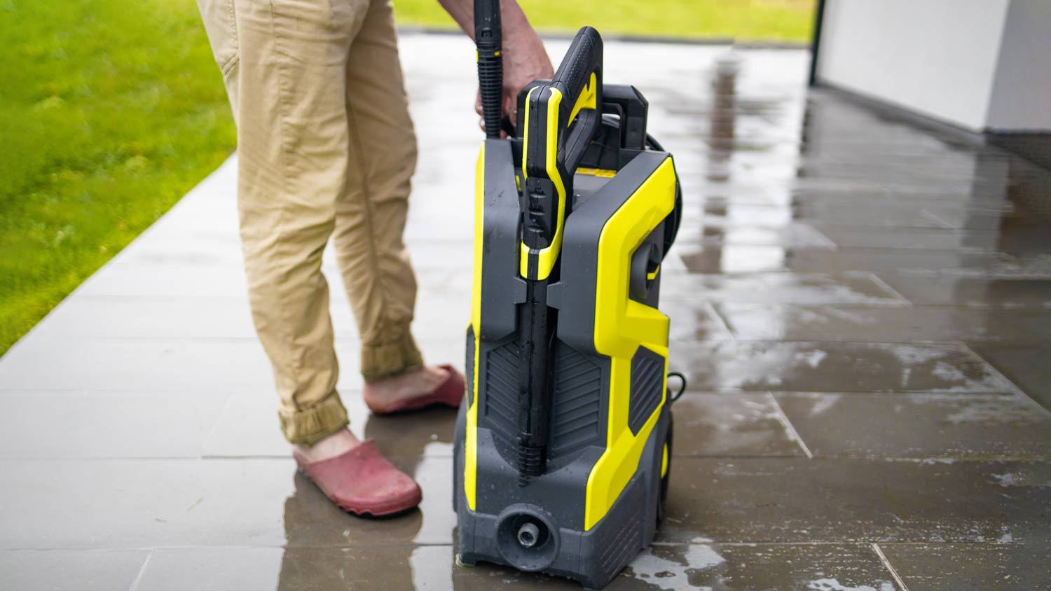 man holding pressure washer machine