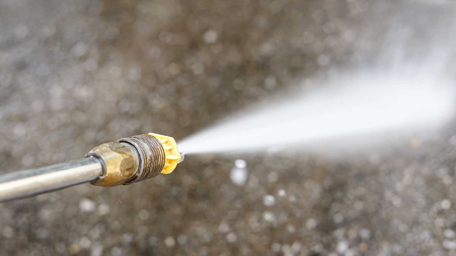 Pressure washer with a yellow nozzle