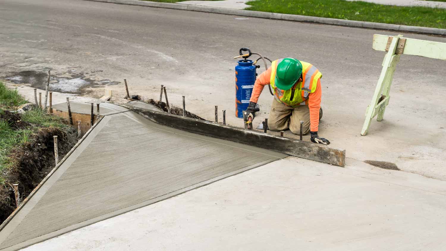 A professional adding a driveway apron