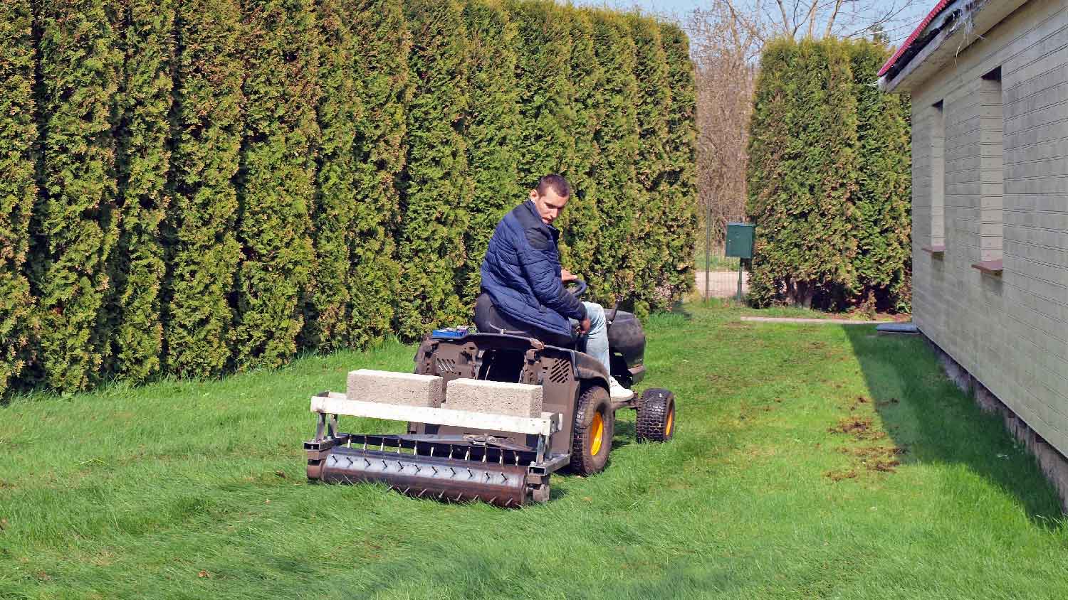 A professional aerating the lawn