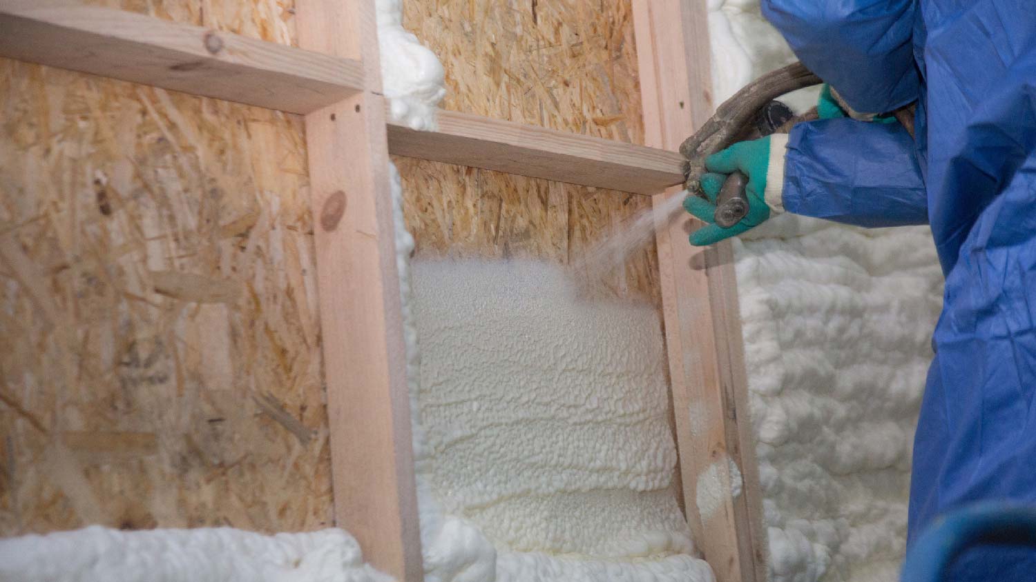 Close-up of a professional applying spray foam insulation