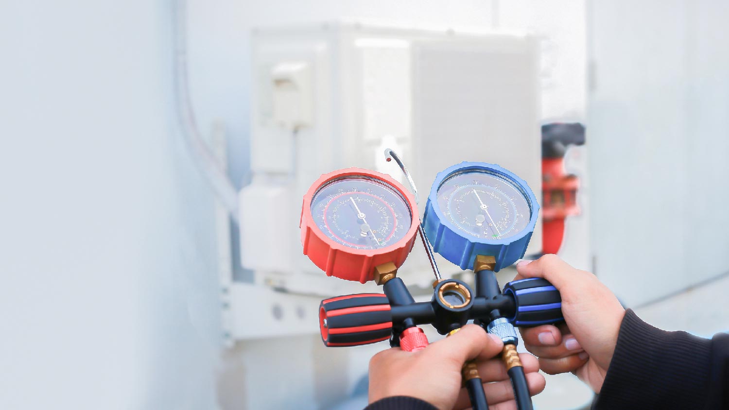 A professional checking a HVAC’s refrigerant 