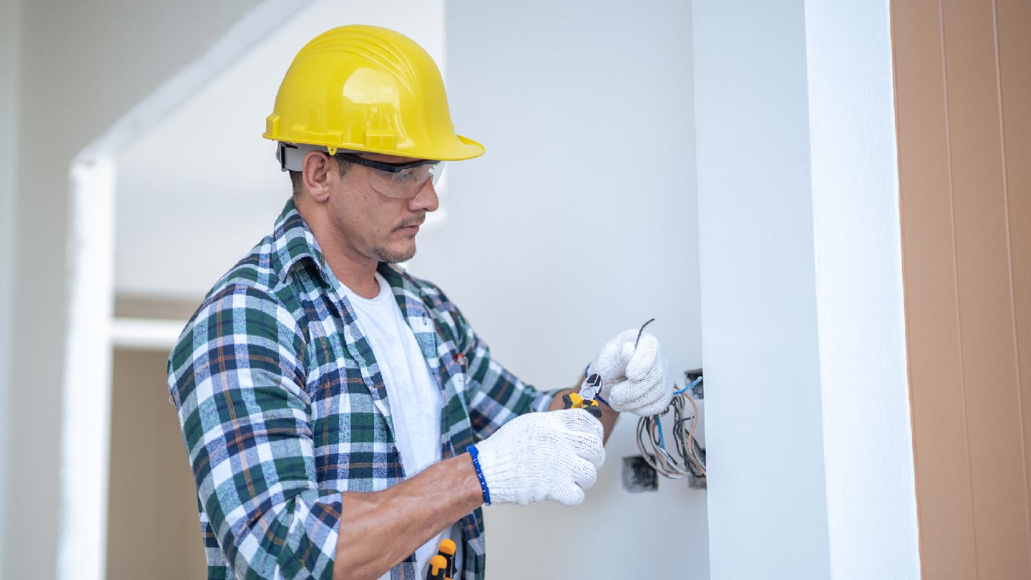 A professional electrical wiring a room