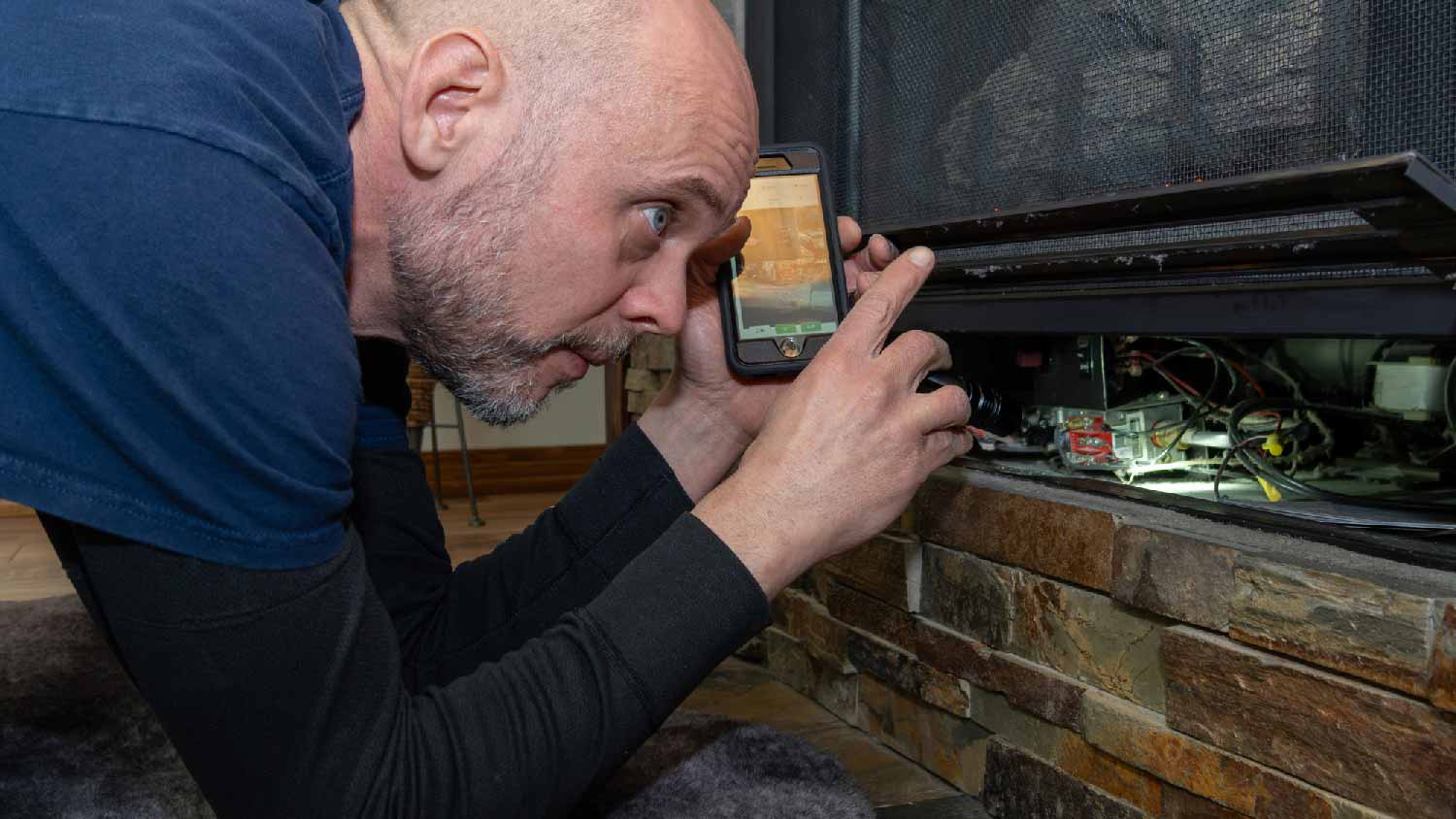 A professional examining an electric fireplace