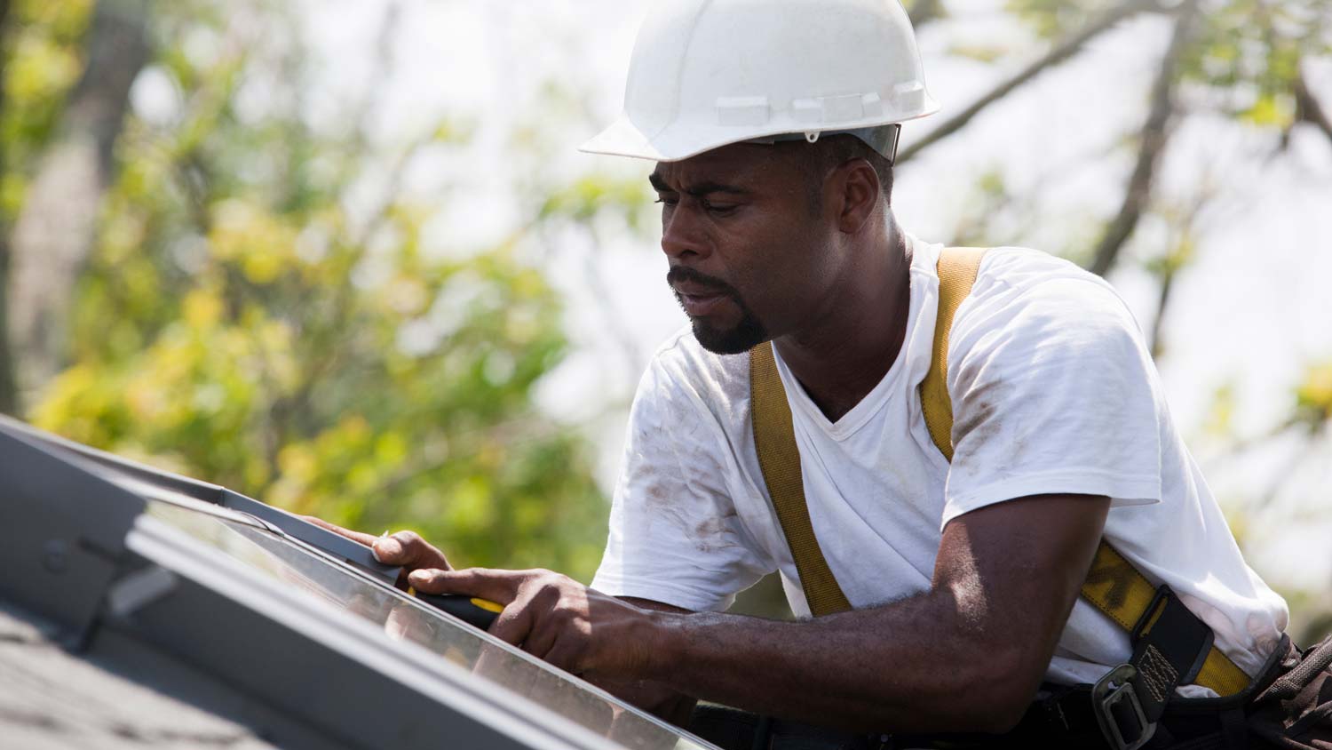 A professional fixing the skylight flashing