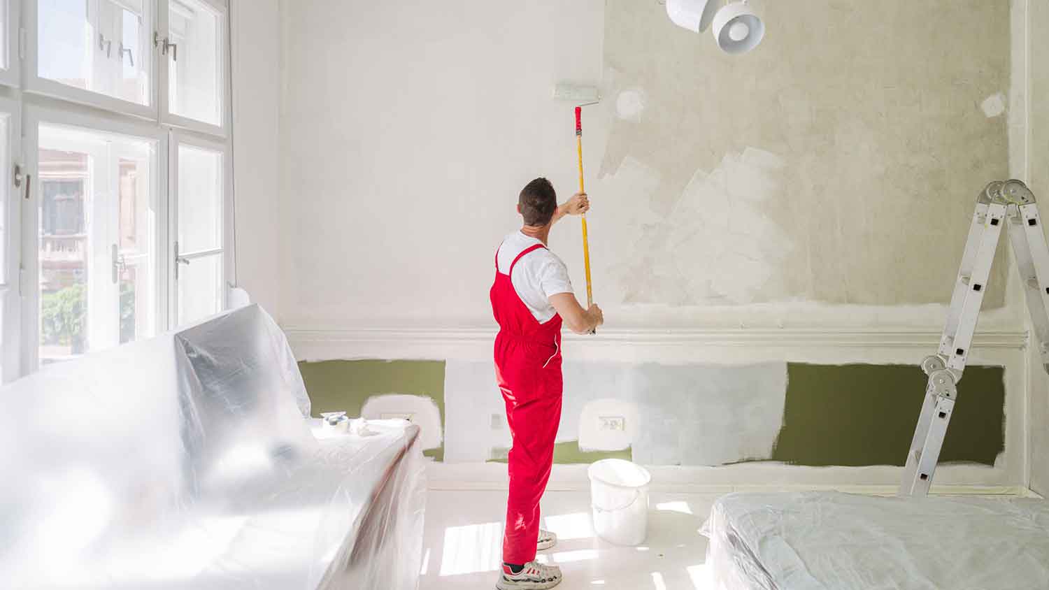 Professional house painter painting a bedroom