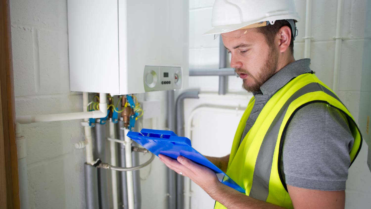 A professional inspecting a boiler