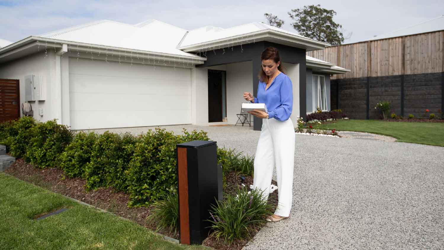 A professional inspecting a driveway