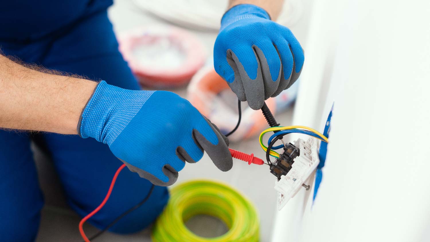 A professional inspecting an electrical outlet