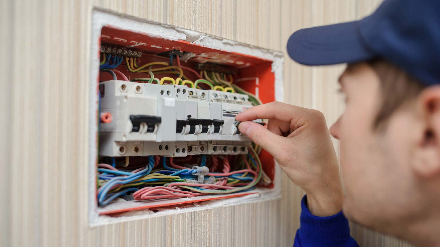 A professional inspecting the electrical wiring
