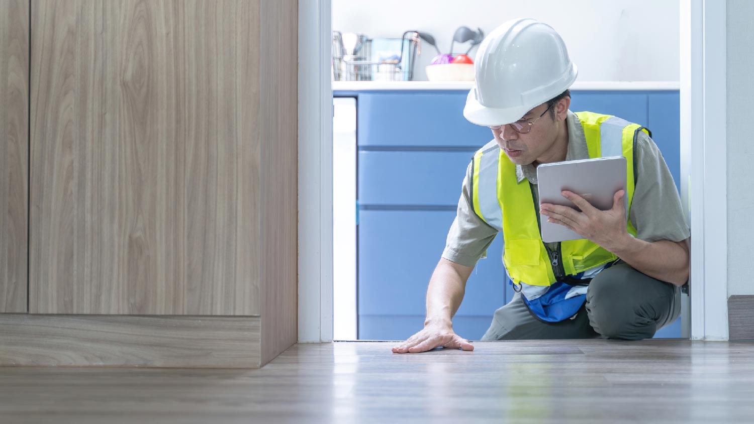 A professional inspecting a floor