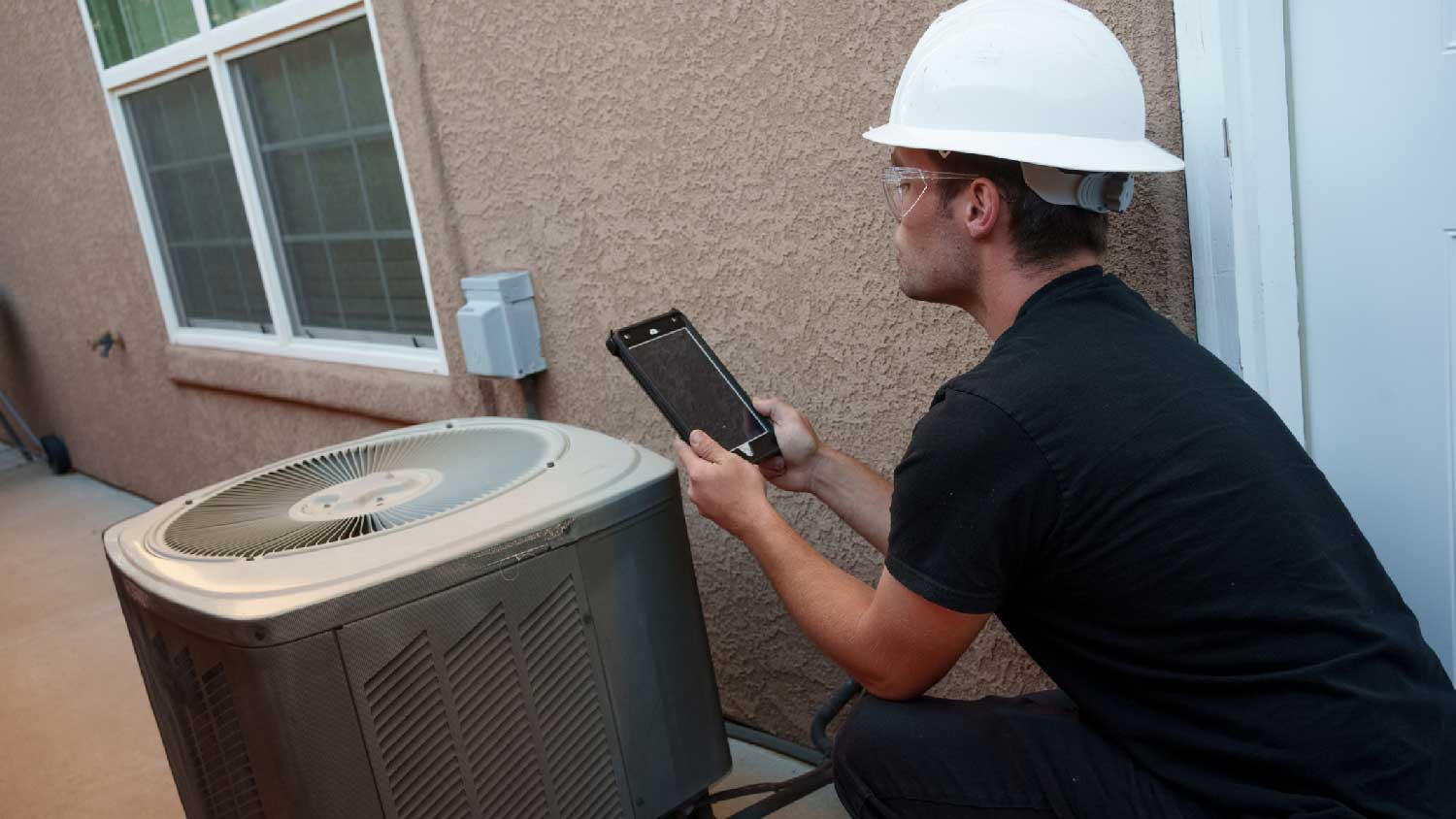 A professional inspecting an HVAC