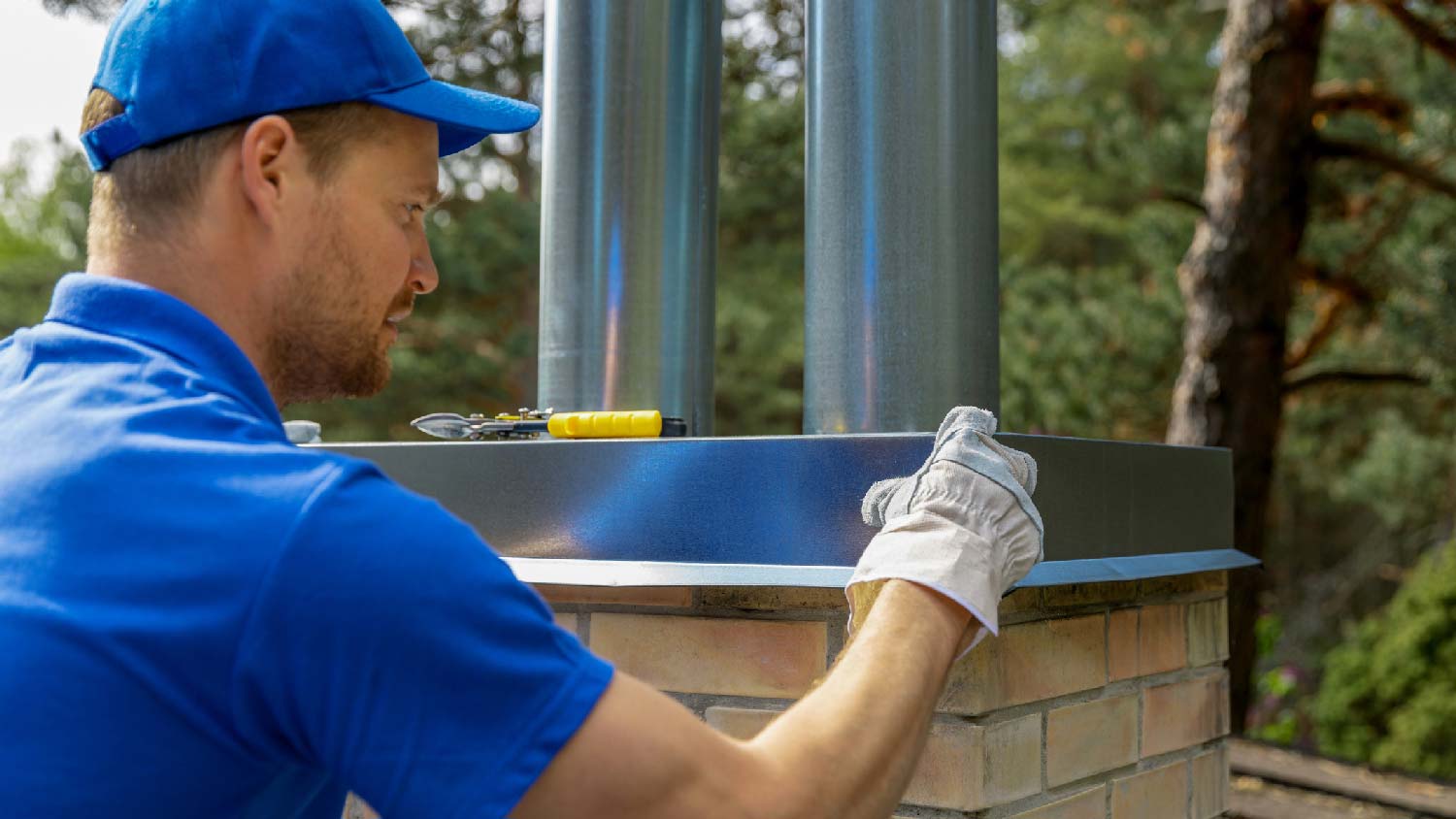 A professional inspecting a metal chimney